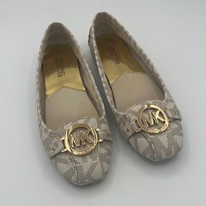 Michael Kors round toe slip on flat shoe with gold logo hardware at toe $70